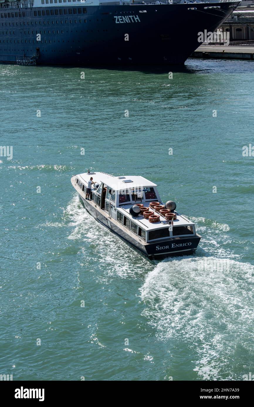 Die großen Kreuzschiffe, die täglich auf Venedig abfahren und mit ihnen Massen eifriger Touristen mit Wassersteuer von Schiff zu Land bringen Stockfoto