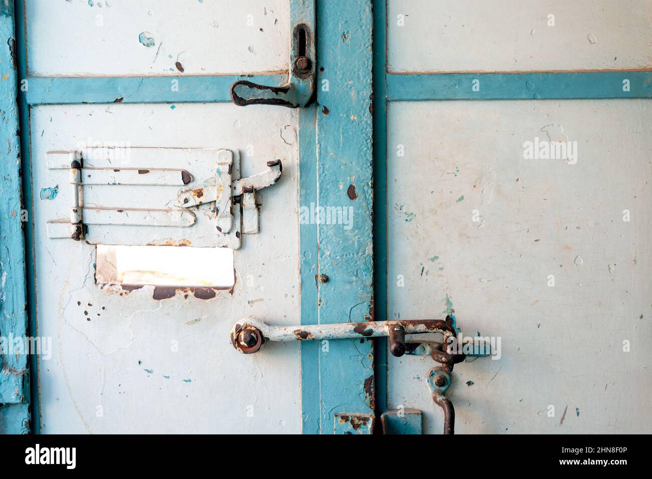 Die unheimliche und rostige Tür zur Gefängniszelle. Das Konzept der Verurteilung und des Strafvollzugsystems. Stockfoto
