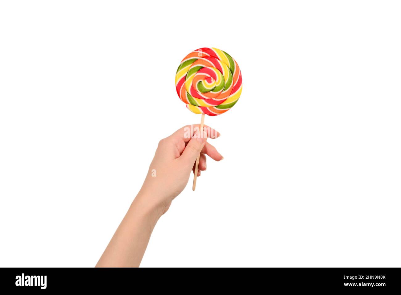 Lollipop in weiblicher Hand isoliert auf weißem Hintergrund. Platz für Text oder Design. Stockfoto