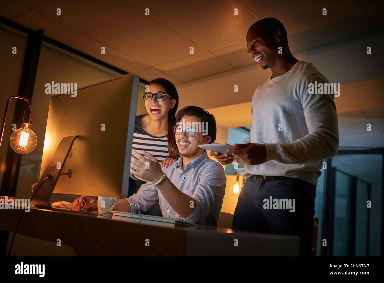Codes knacken macht sie glücklich. Aufnahme von Computerprogrammierern, die spät im Büro zusammenarbeiten. Stockfoto