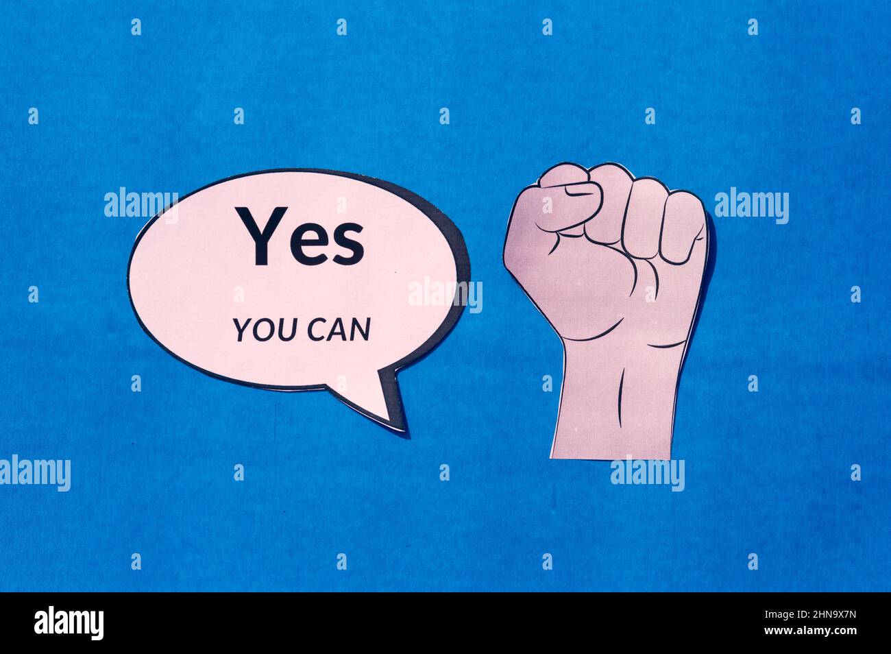 Feste menschliche Hand mit Motivationstext Ja, Sie können auf Sprechblase isoliert auf blauem Hintergrund. Das konzeptuelle Bild zeigt, dass Sie die Fähigkeit str Stockfoto
