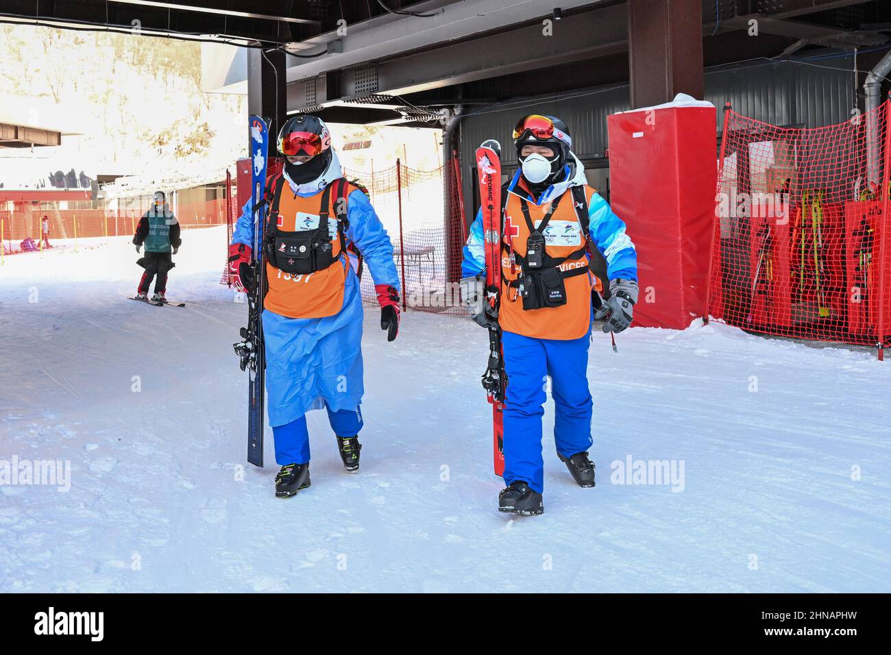 (220215) -- PEKING, 15. Februar 2022 (Xinhua) -- Huai Wei (L) geht zu seinem Dienstplatz auf der Skipiste im Nationalen Alpinen Skizentrum im Bezirk Yanqing, Peking, Hauptstadt von China, 14. Februar 2022. Huai Wei, stellvertretender Chefarzt der Notaufnahme des dritten Krankenhauses der Universität Peking, leistet zusammen mit vier anderen Kollegen derzeit seinen Dienst als Skiarzt für das Ski-Alpin-Event der Olympischen Winterspiele 2022 in Peking im Nationalen Ski-Zentrum in Zhangjiakou in der Provinz Hebei. Huai ist stationiert, um jedem verletzten Sportler sofort medizinische Hilfe zu leisten Stockfoto