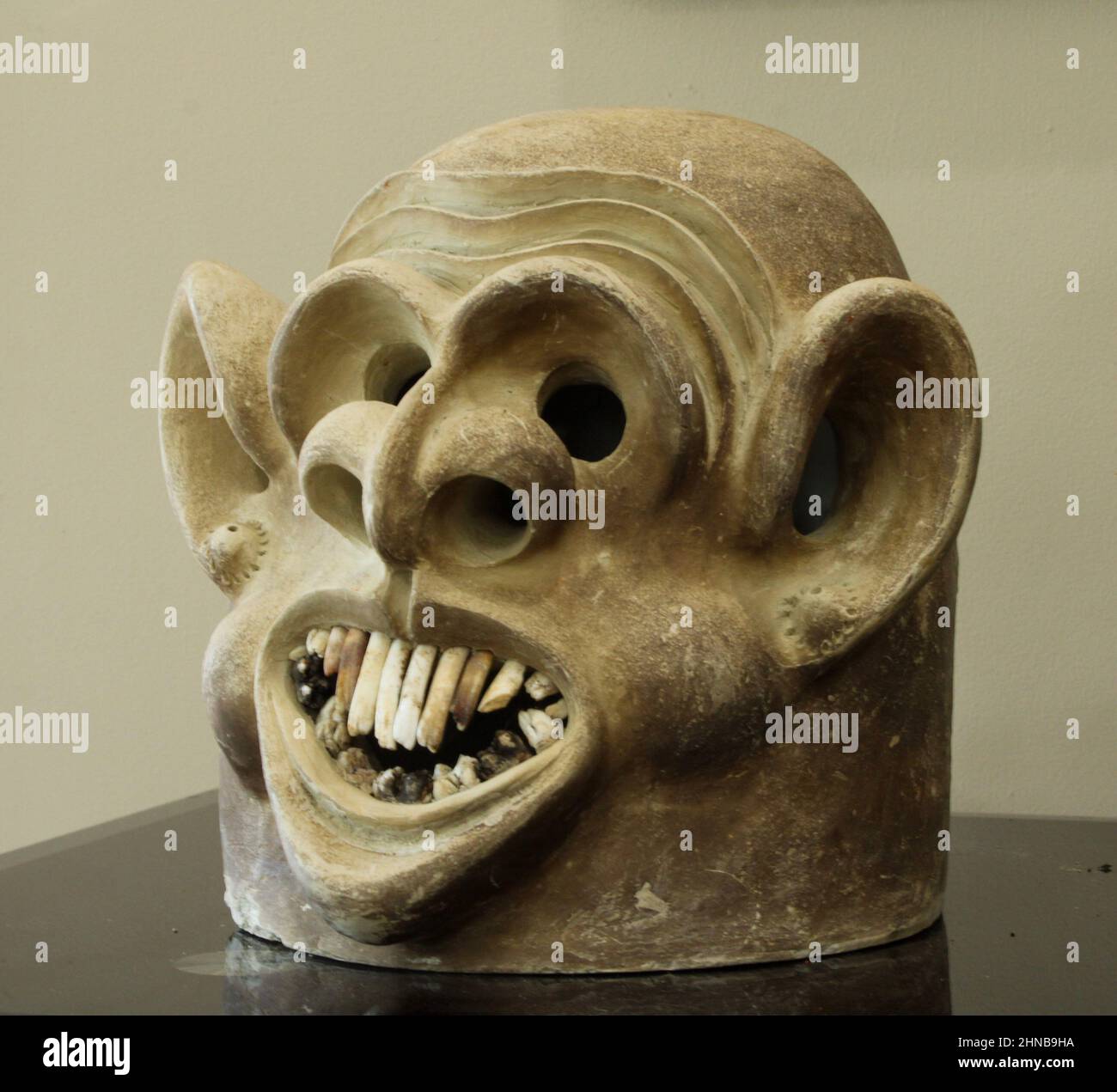 Asaro Mudman Tonmaske aus Papua-Neuguineas östlichen Highlands, mit einem grotesk lächelnden Gesicht und übertriebenen Ohren, die als einzigartige Einrichtung für Stammeskunst verwendet wird Stockfoto