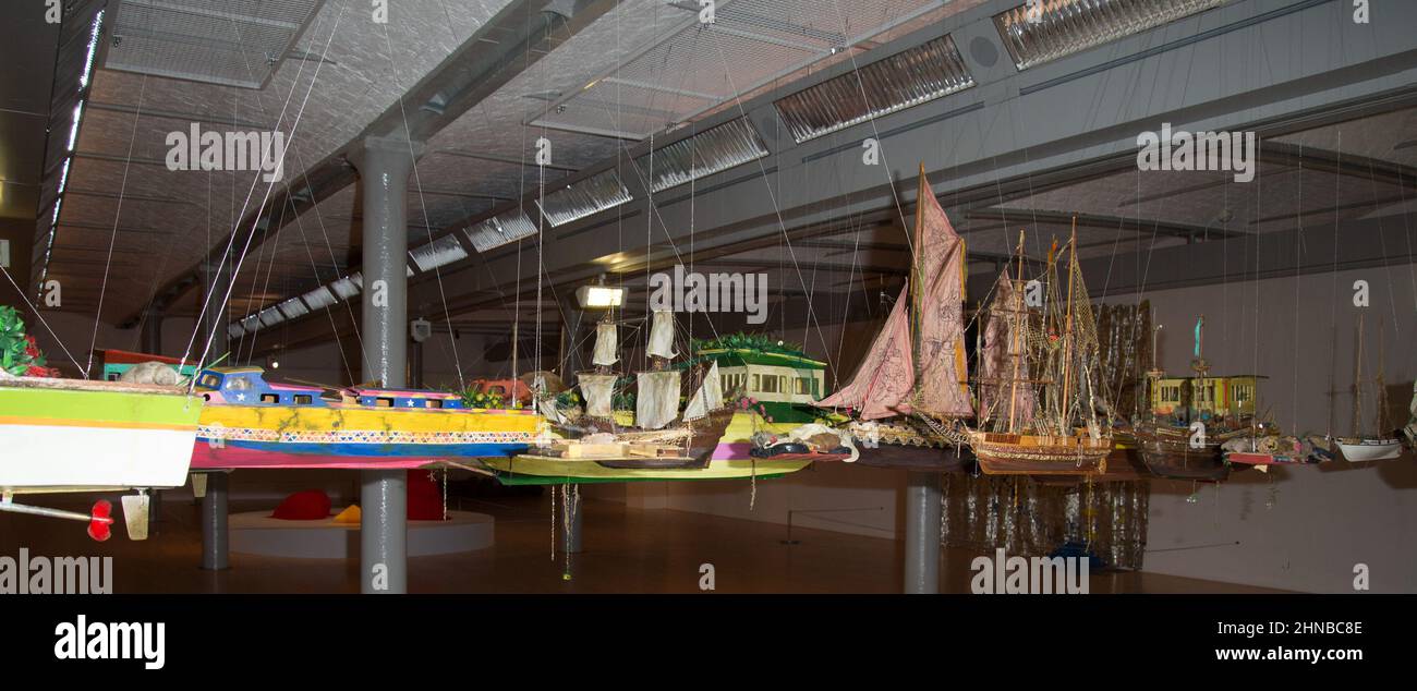 Hew Lockes Armada 2019, eine immersive Großinstallation, die aus einer Flottille von Booten und Flößen besteht. Eine Reihe von Frachtschiffen, Fischerbooten, Karavellen und Galeonen aus verschiedenen historischen Epochen und Orten werden in Schulterhöhe von der Decke abgehängt, wobei jedes Boot aus verschiedenen Materialien gefertigt und mit einer Vielzahl von Materialien verziert wird. Einige verfügen über Netze und Dekorationen, während andere Juwelen, Reize, Militärabzeichen und Nachahmemedaillen aus der Karibik, Syrien und anderswo enthalten. Die neuen Displays werden mehr als 80 Werke zeigen, die sich mit den Themen Bewegung, Migration und International beschäftigen Stockfoto
