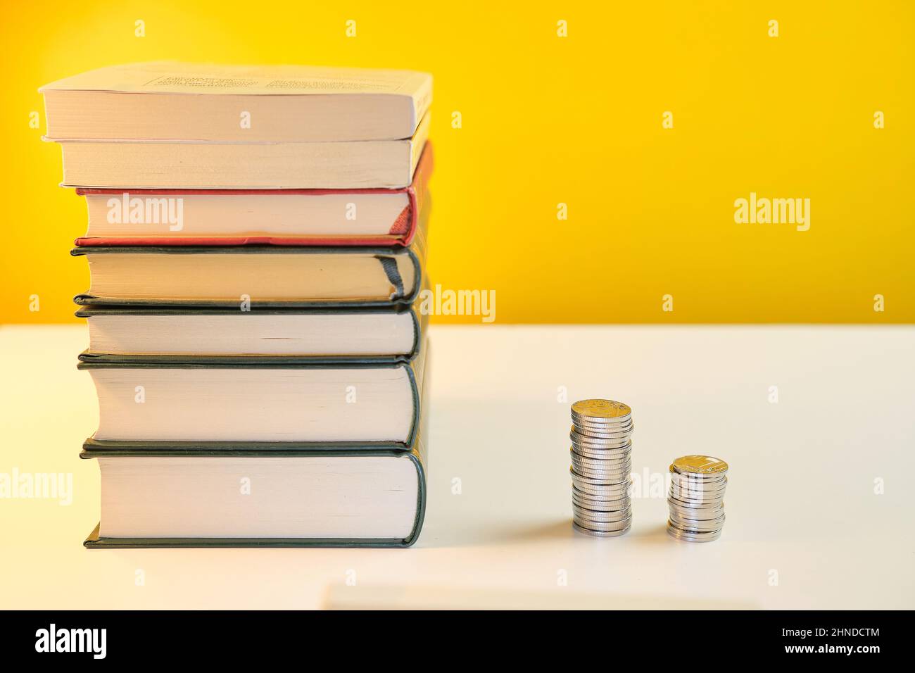 Lesen Sie Bücher und erhalten Sie reich Geld verdienen lernen, bevor verdienen Konzept gelben Hintergrund Stockfoto
