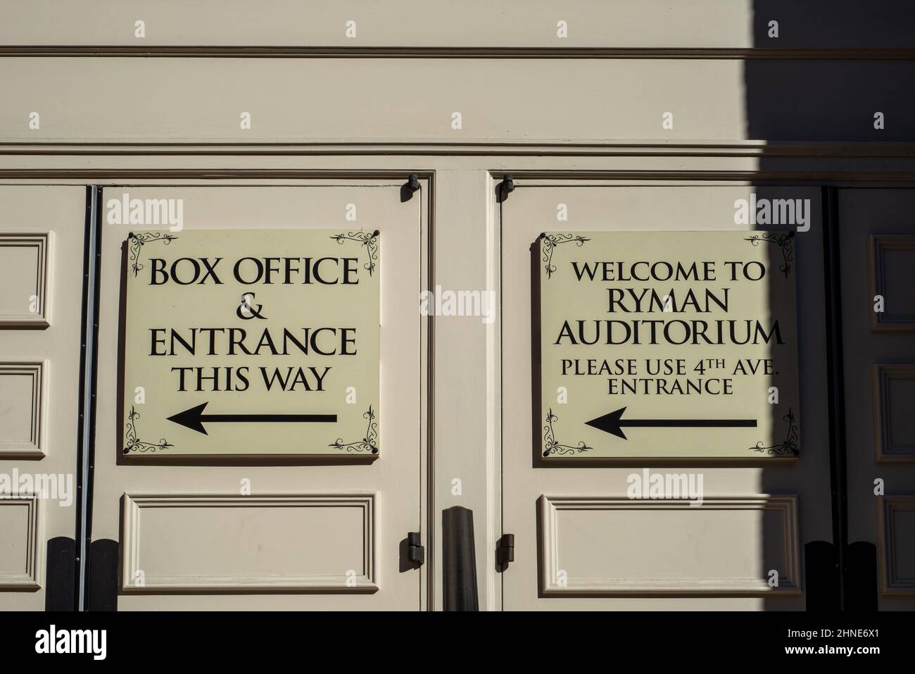 Weiße Schilder mit schwarzen Schriftzügen und Pfeilen begrüßen Besucher des Ryman Auditorium in Nashville, Tennessee, und zeigen auf die Kasse und den Eingang. Stockfoto