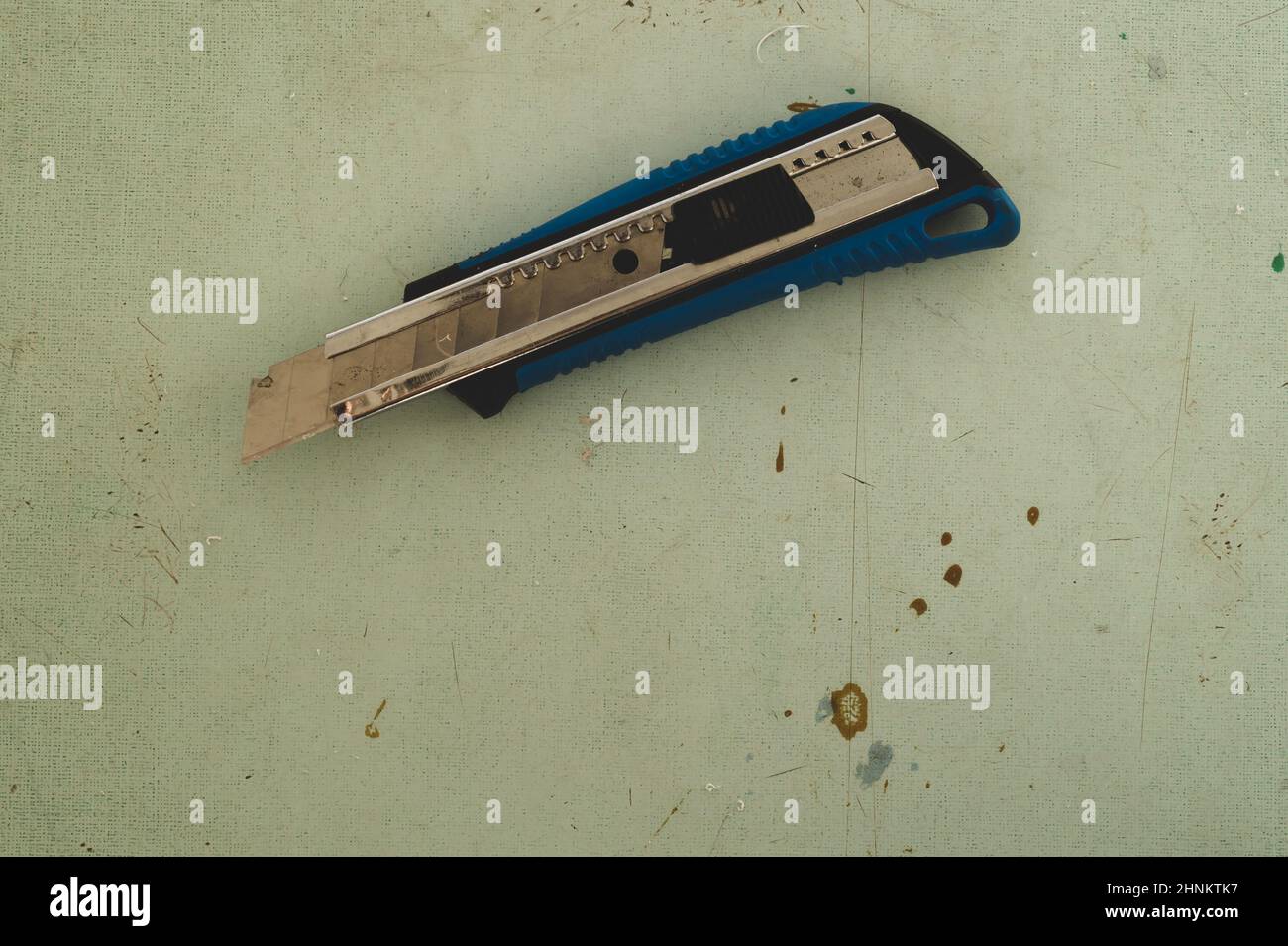 Schreibwarenmesser auf dem Holzboden. Schneidemesser auf der Arbeitsfläche Stockfoto