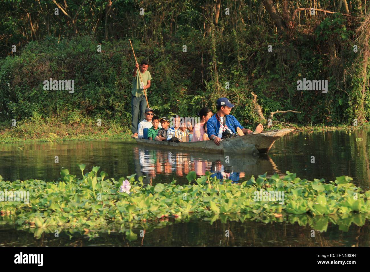Menschen auf einer Bootsfahrt am Fluss im Chitwan Nationalpark in Nepal, um Tiere wie Krokodile, Vögel und Fische zu beobachten Stockfoto