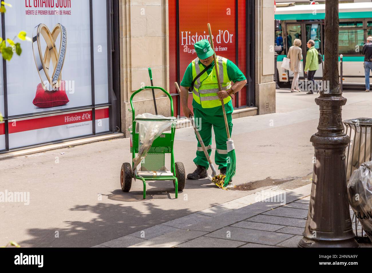 Straßenputzer fegt den Boden auf dem Bürgersteig in Paris, Frankreich Stockfoto