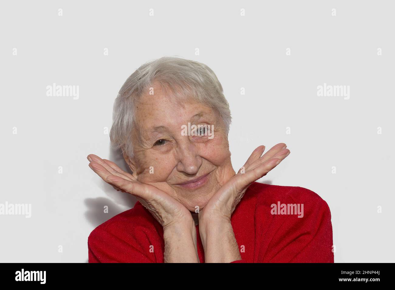 Das Porträt einer fröhlichen älteren Frau, die den Sieg gestikuliert Stockfoto