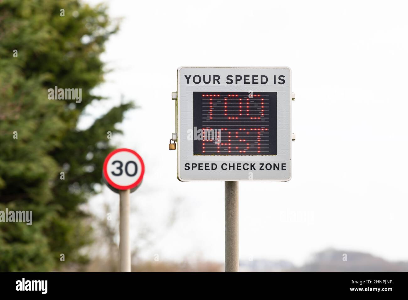 Geschwindigkeitsüberschreitung in 30mph Zonen - Fahrzeug aktiviert Geschwindigkeitsanzeige Gerätesymbol mit der Meldung 'Ihre Geschwindigkeit ist zu schnell' - England, Großbritannien Stockfoto