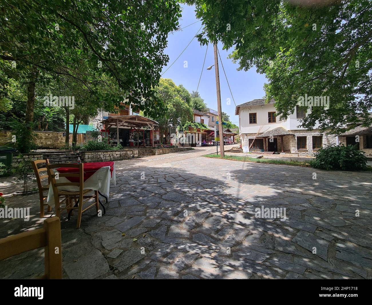 Ioannina, Griechenland - 01. Juli 2021: Schattiger Gastgarten eines Restaurants auf der kleinen Insel im Pamvotis See Stockfoto