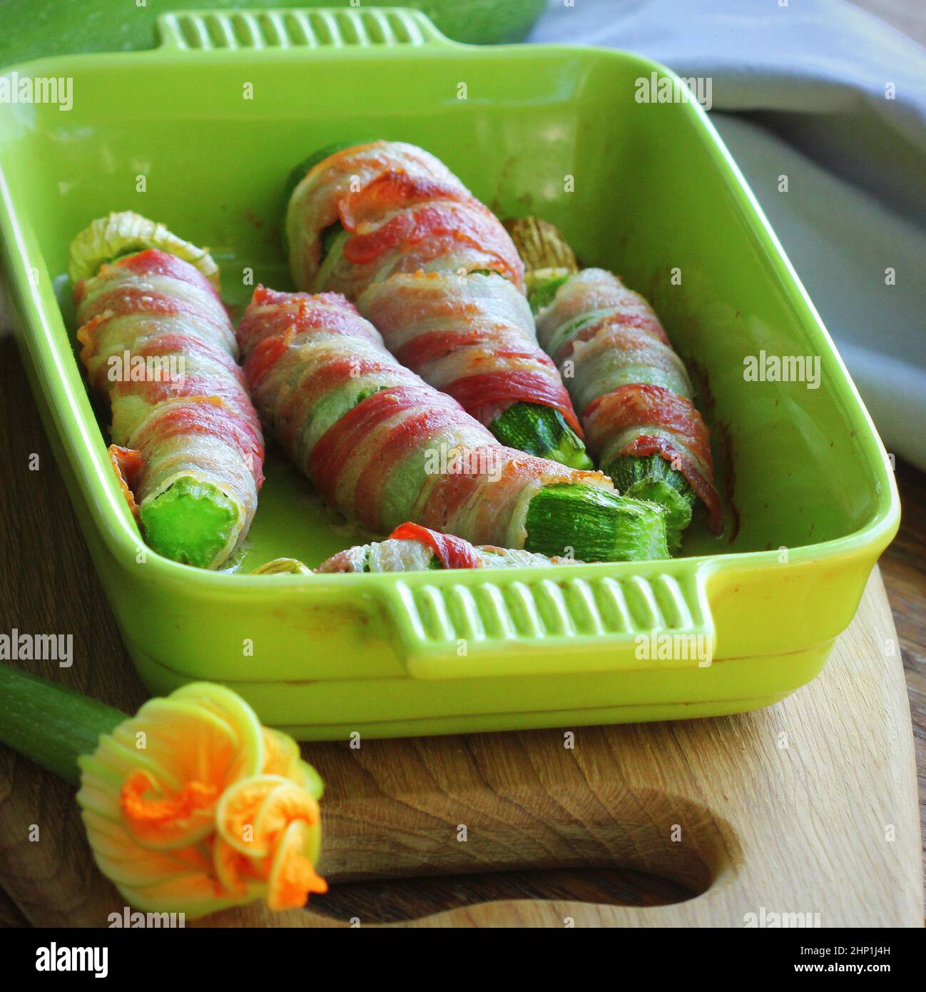 Gegrillte Zucchini Pommes in einem Speck in der Pfanne eingewickelt. Stockfoto