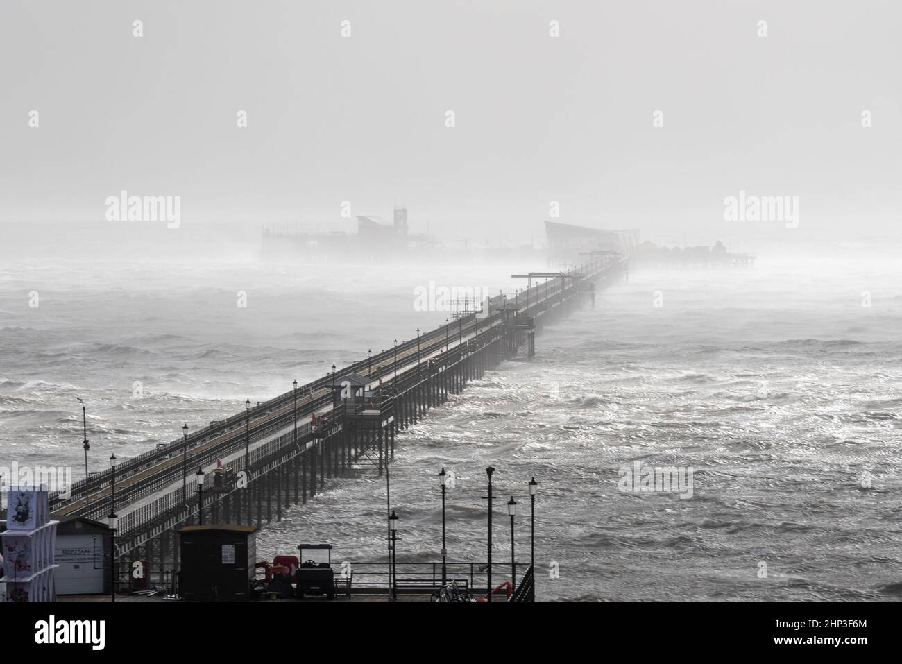 Southend on Sea, Essex, Großbritannien. 18th. Februar 2022. Der Sturm Eunice hat die Stadt an der Themse getroffen und einige Schäden verursacht, die die Menschen an die Küste locken. Southend Pier in schwerer See Stockfoto