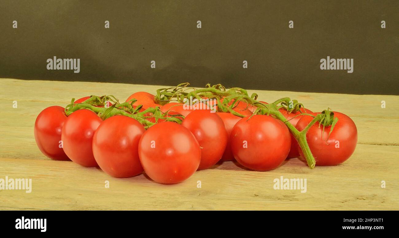 Frische Kirschtomaten auf rustikalem Holzhintergrund. Weißer und schwarzer Hintergrund. Platz für Text kopieren. Stockfoto