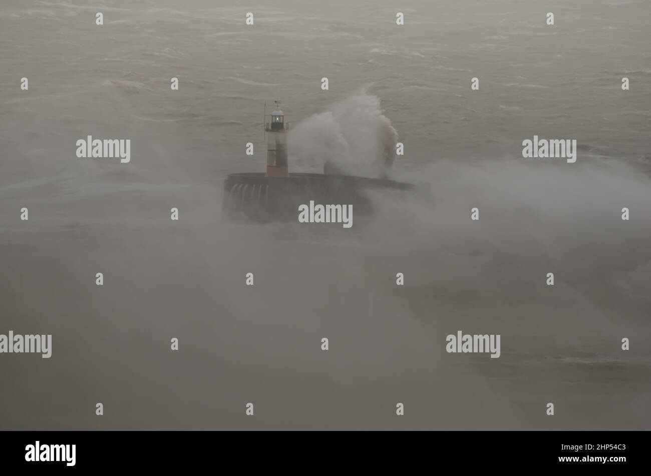 Newhaven, East Sussex, Großbritannien. 18th. Februar 2022. Der Sturm Eunice schlägt die Kanalküste mit seinen westlichen Winden. Der Leuchtturm von Newhaven war während des Ansturms selten zu sehen, als massive Wellen und Spray den West Harbour Arm überschwemmten. Kredit: David Burr/Alamy Live Nachrichten Stockfoto
