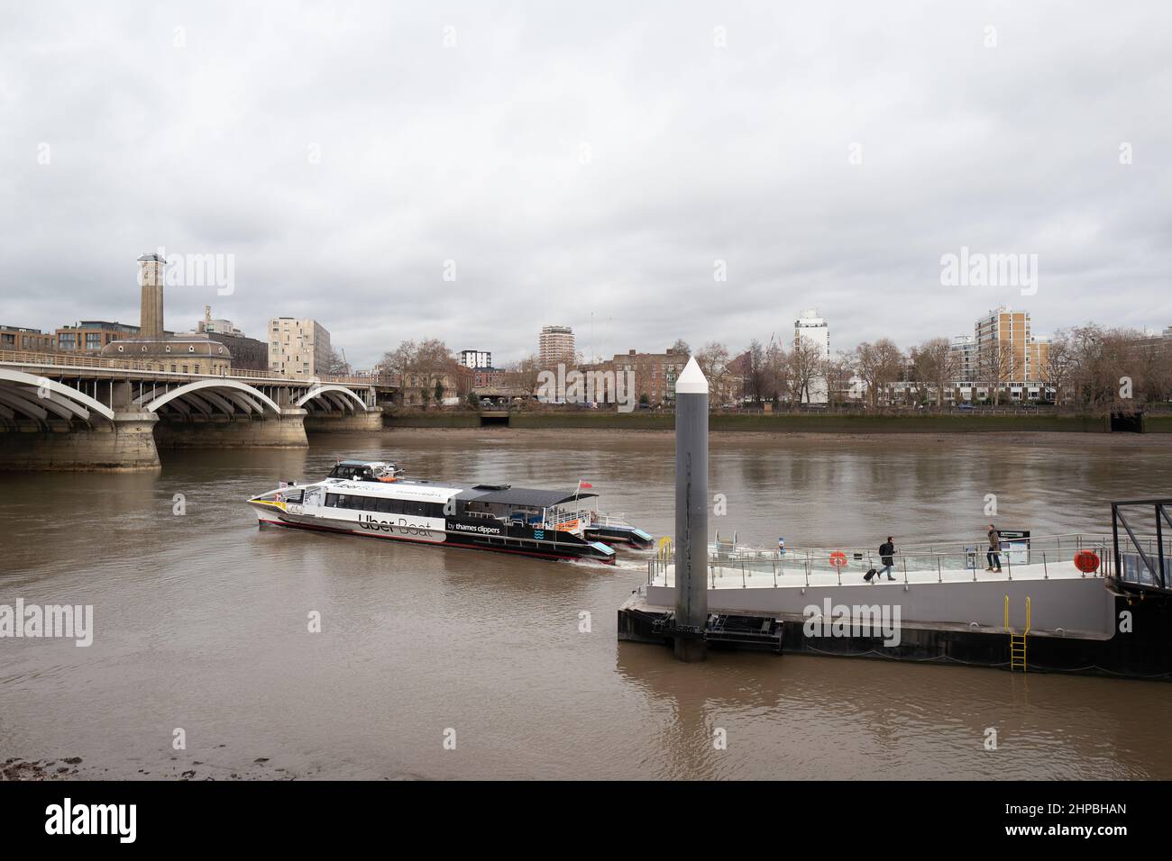Ein von Uber gesponsertes Flussboot verlässt den Anlegesteg auf der Themse im Battersea Power Station, London, Großbritannien Stockfoto