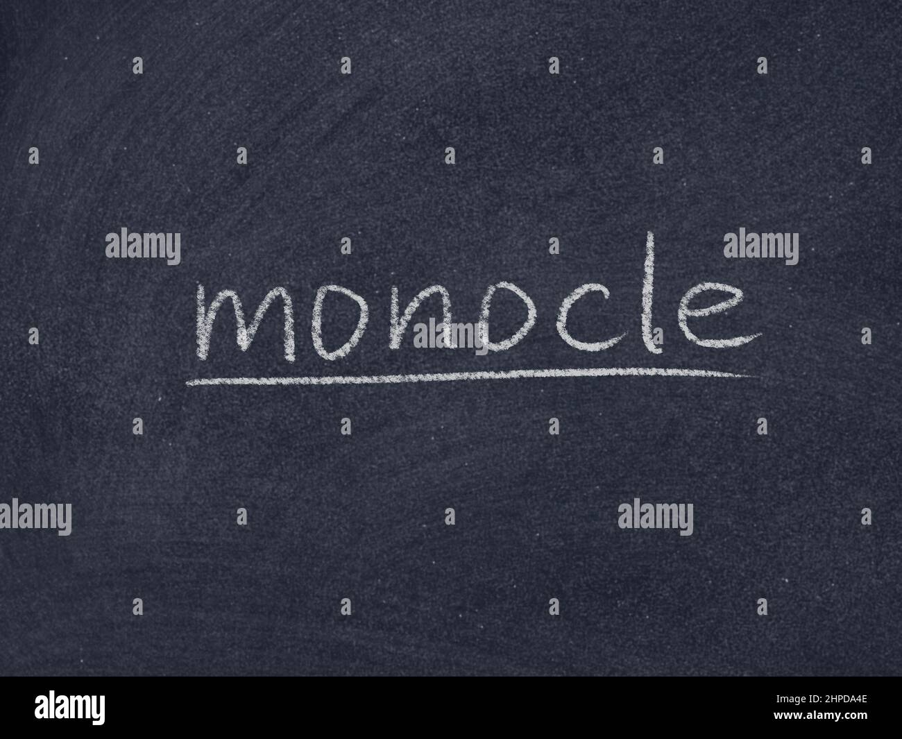 monocle Konzept Wort auf Tafel Hintergrund Stockfoto