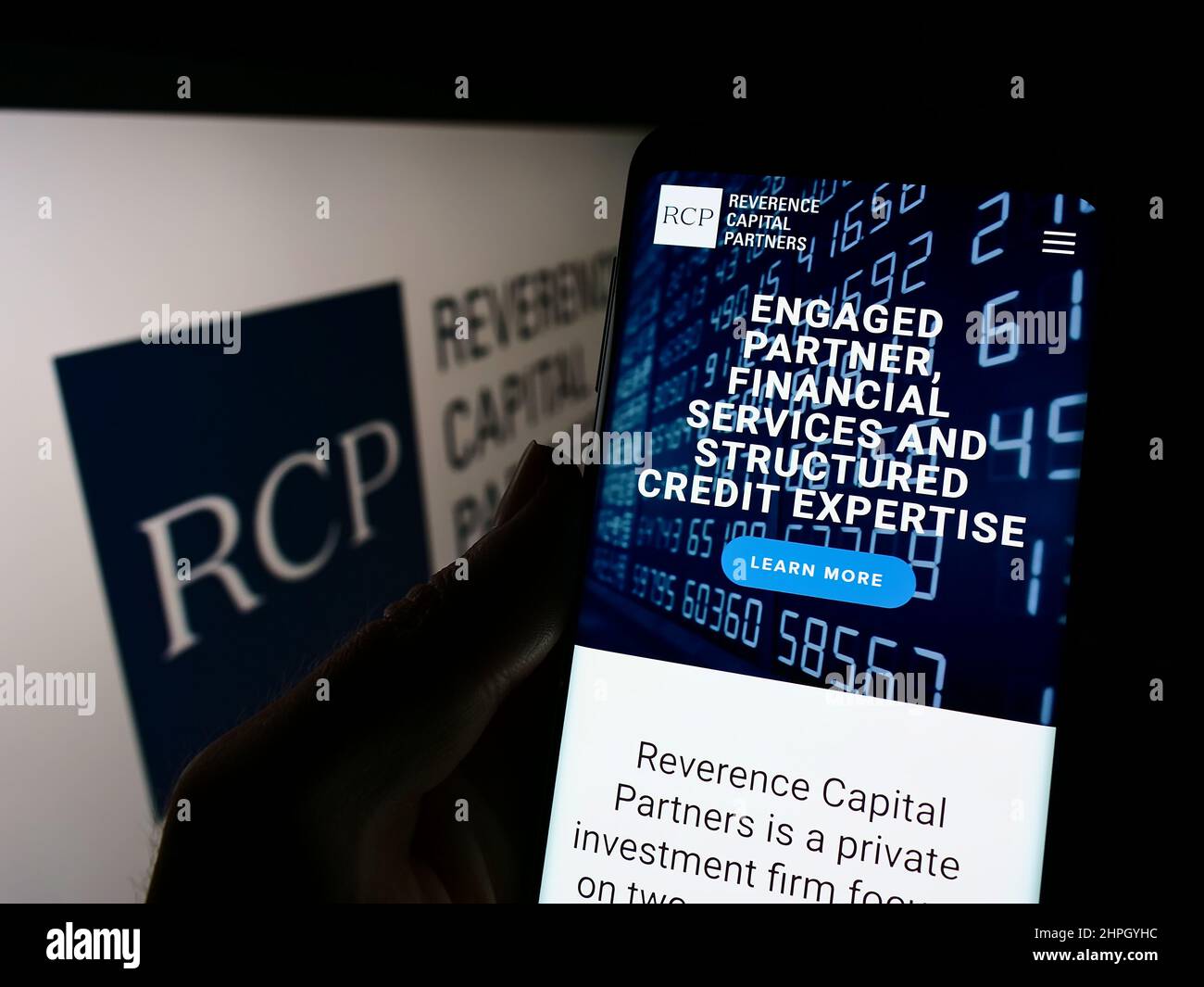 Person, die Mobiltelefon mit der Website des US-Unternehmens Reverence Capital Partners L.P. hält (RCP) auf dem Bildschirm mit Logo. Konzentrieren Sie sich auf die Mitte des Telefondisplays. Stockfoto