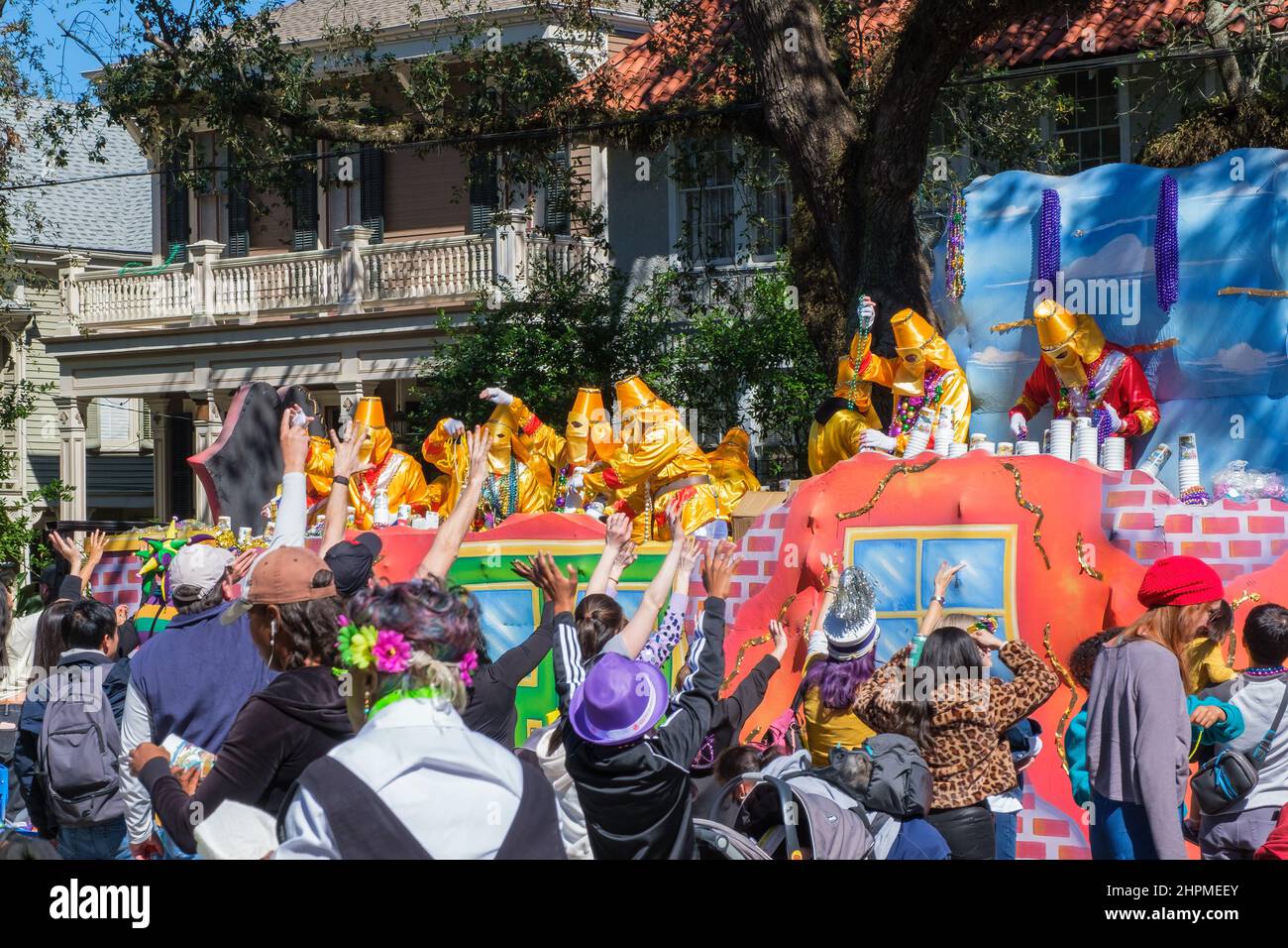 NEW ORLEANS, LA, USA - 19. FEBRUAR 2022: Floßfahrer werfen Perlen in die Menge bei der Karnevalsparade der Krewe of Ponchartrain auf der Napoleon Avenue Stockfoto