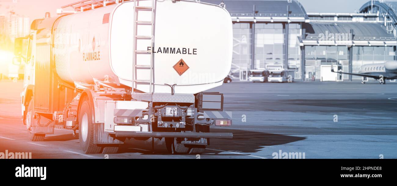 Rückansicht kleiner moderner Tankwagen, der auf dem Rollweg des Flugplatzes zum Betanken von Flugzeugen fährt. Zisterne LKW Luftfahrt Benzin. Gasversorgung des Flugzeugs Stockfoto