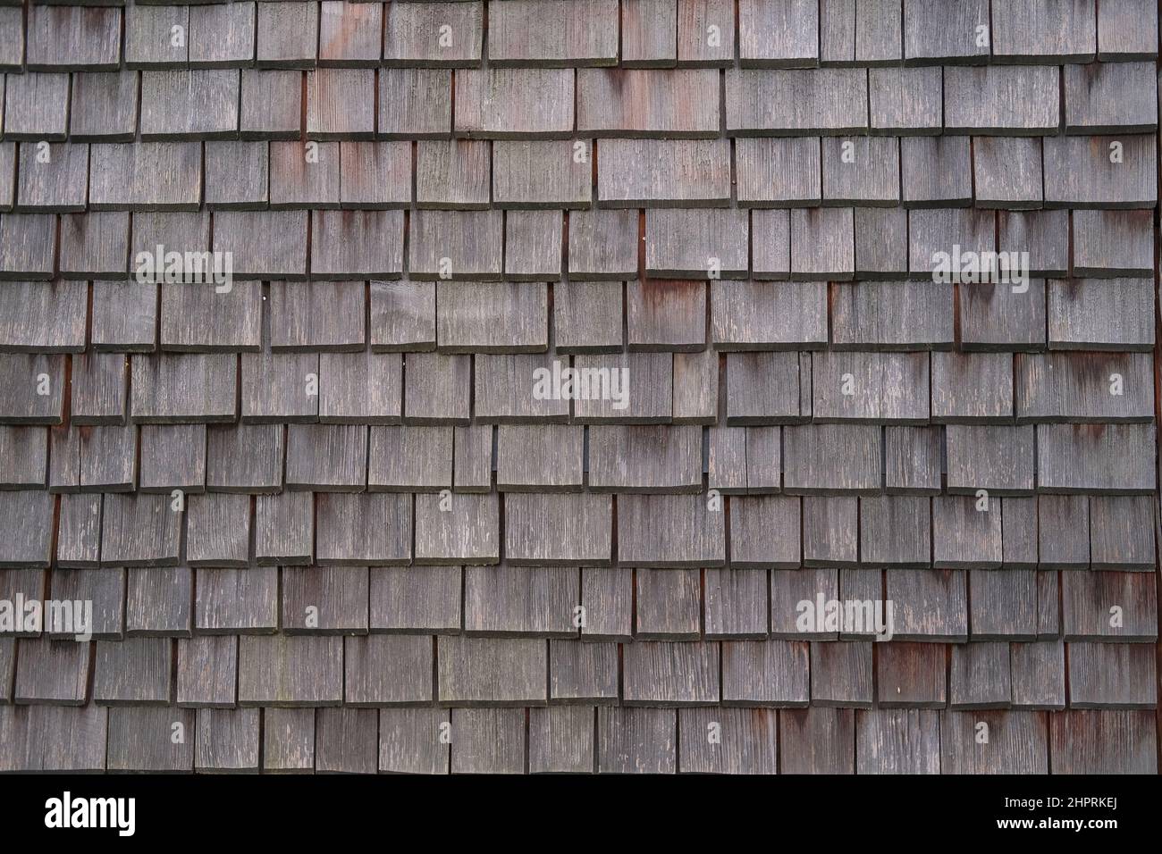 Schindelholz Holzfliesen Fassade Hintergrund.Textur der alten verwitterten Holz Fliesendach oder Oberfläche der natürlichen Furnier Wand Hintergrund. Eco-Hintergrund. Stockfoto