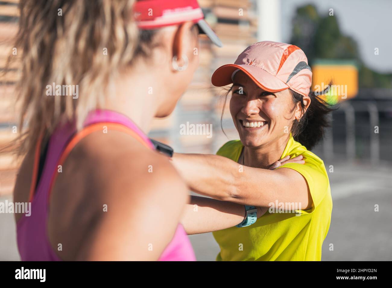 Zwei multiethnische Mädchen strecken sich gemeinsam zum Sport. Paar. Schwul. Stockfoto