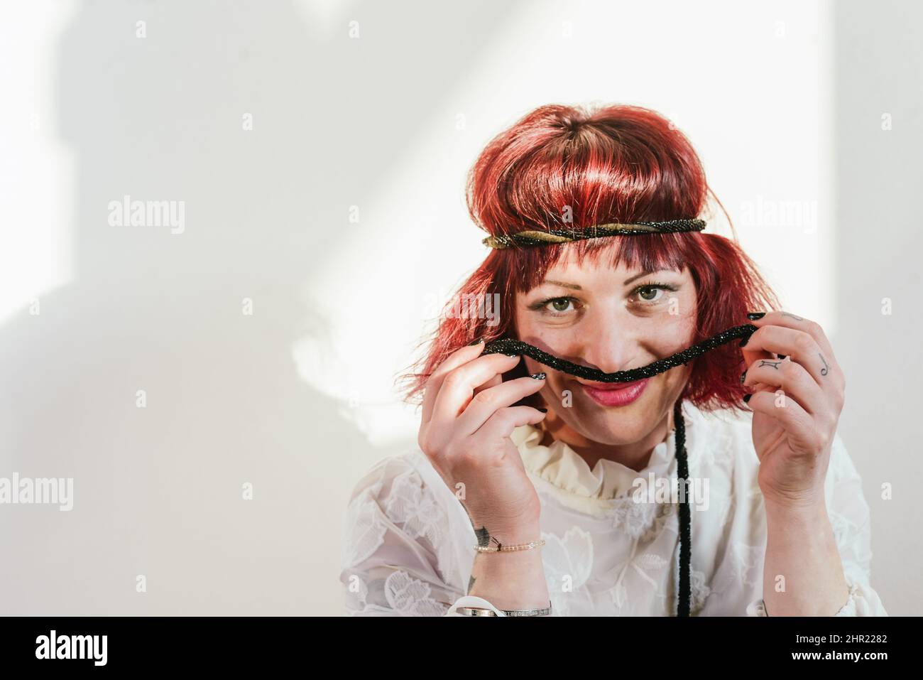 Verspielte kaukasische junge Erwachsene Rotschopf Frau Spaß im Studio einen sonnigen Tag Stockfoto