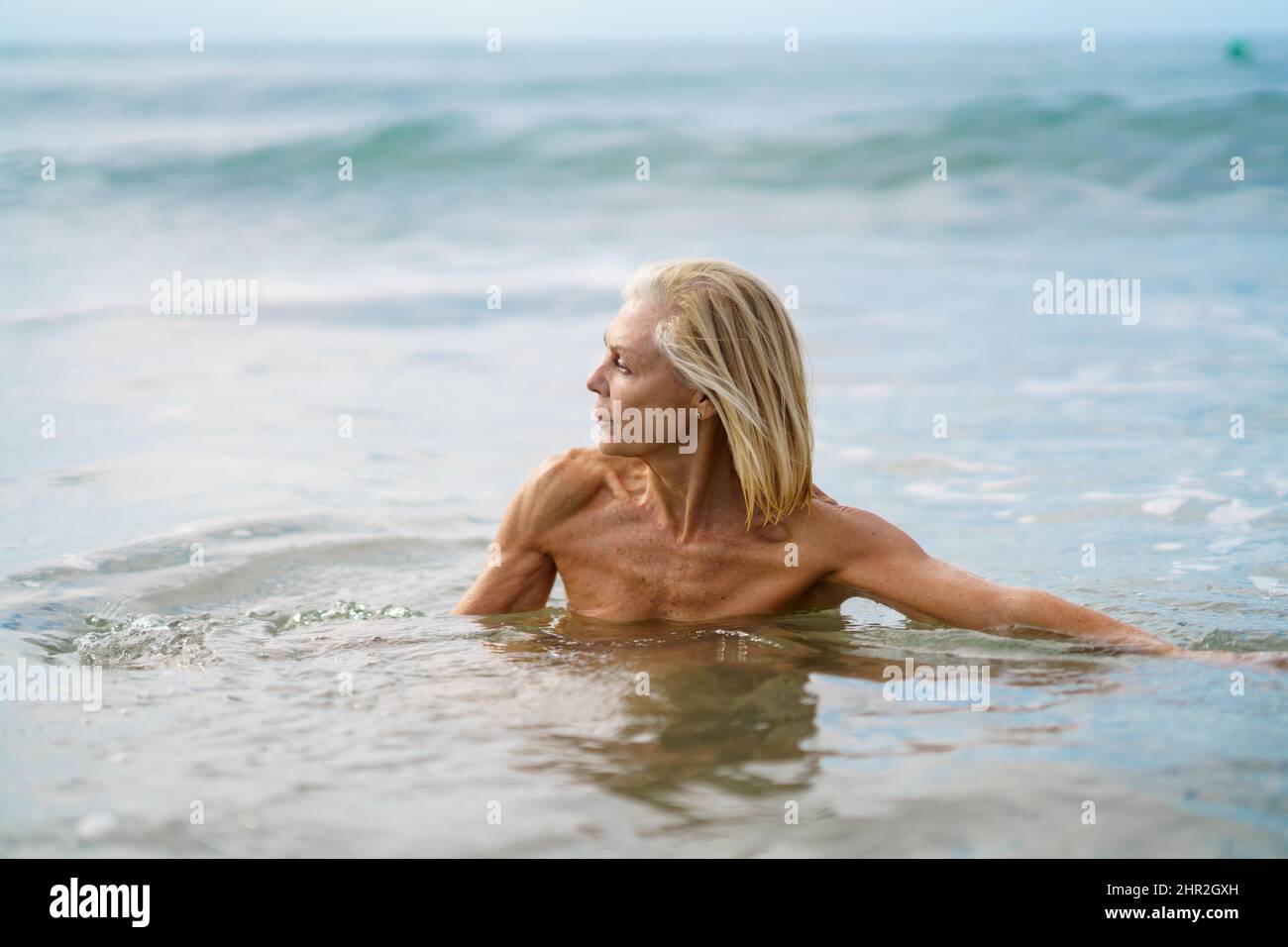 Reife Frau in gutem Zustand Baden im Meer. Stockfoto