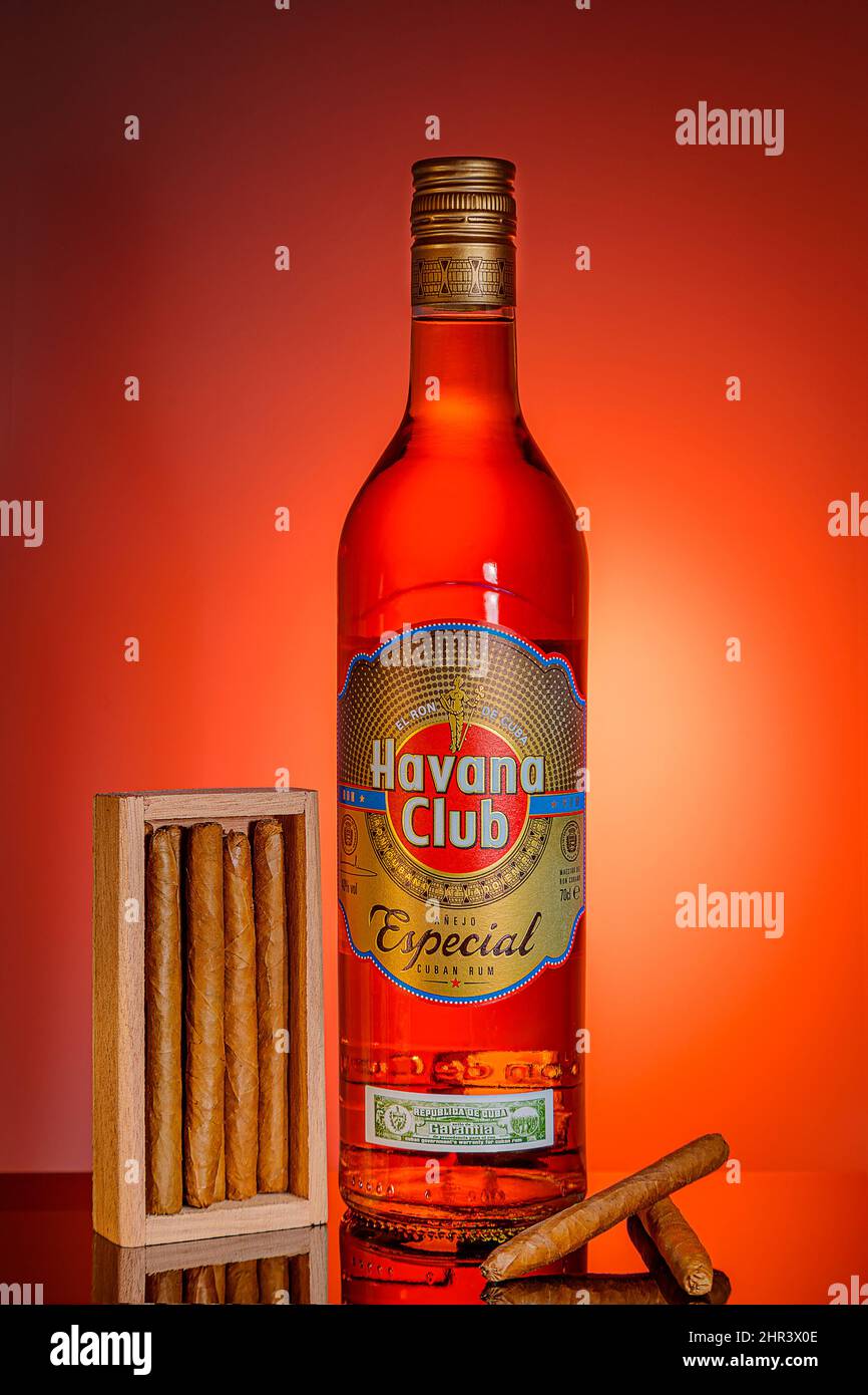 Flasche kubanischer Rum mit Zigarren auf orangefarbenem Hintergrund. Werbeaufnahmen. Moskau Russland 21. Februar 2022. Stockfoto