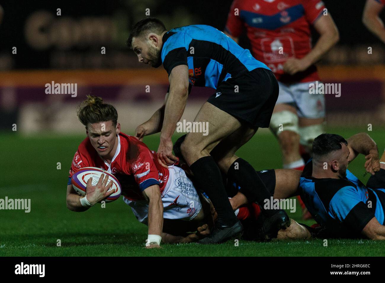 Llanelli, Großbritannien. 25. Februar 2022. Llanelli RFC Scrum Half Harri Williams wird während des Llanelli RFC gegen Cardiff RFC Indigo Group Premiership Rugby Match in Angriff genommen. Kredit: Gruffydd Thomas/Alamy Stockfoto