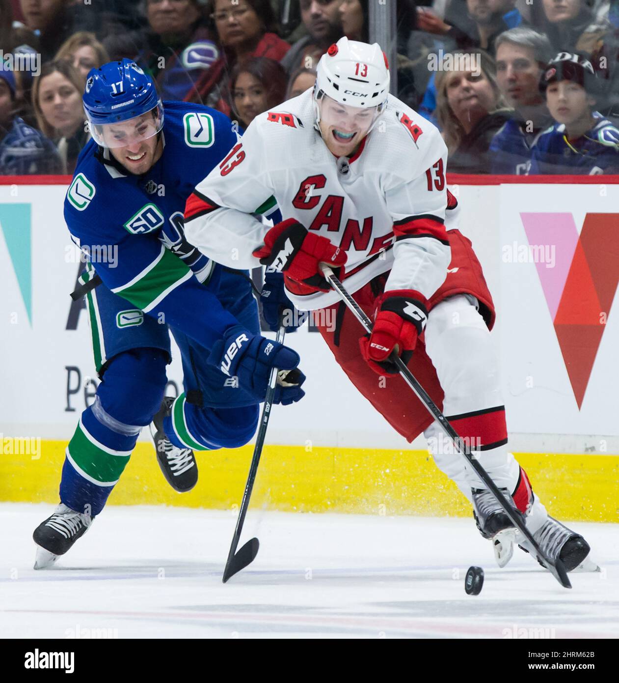 Warren Foegele (13) von Carolina Hurricanes spielt mit dem Puck, während er von Josh Leivo (17) von Vancouver Canucks während der dritten Periode eines NHL-Hockeyspiels in Vancouver, am Donnerstag, dem 12. Dezember 2019, verfolgt wird. DIE KANADISCHE PRESSE/Darryl Dyck Stockfoto