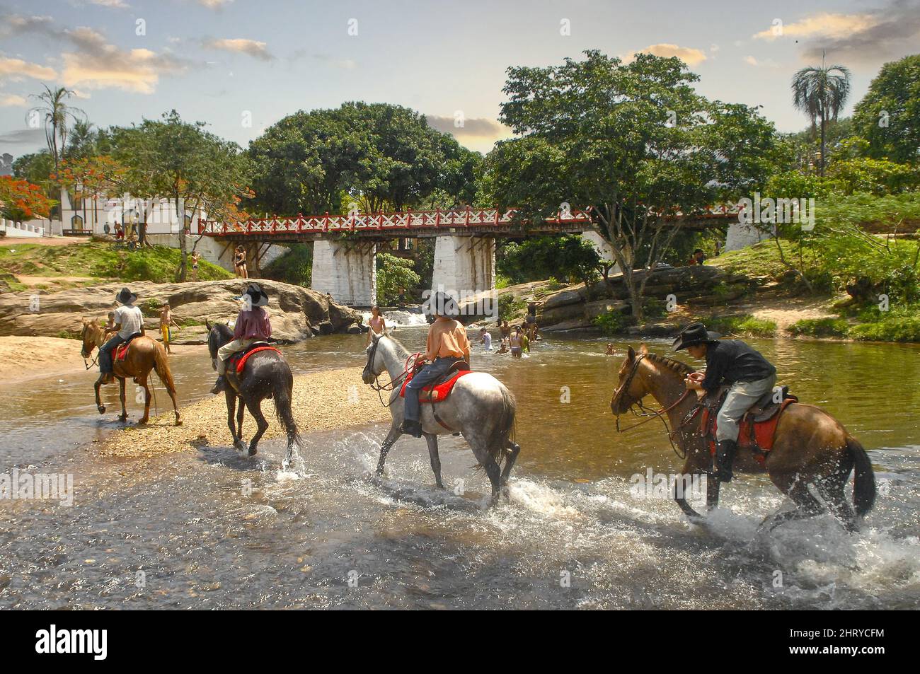 Nahaufnahme von Menschen, die auf Pferden durch den Fluss der Seelen in Pirenopolis reiten Stockfoto