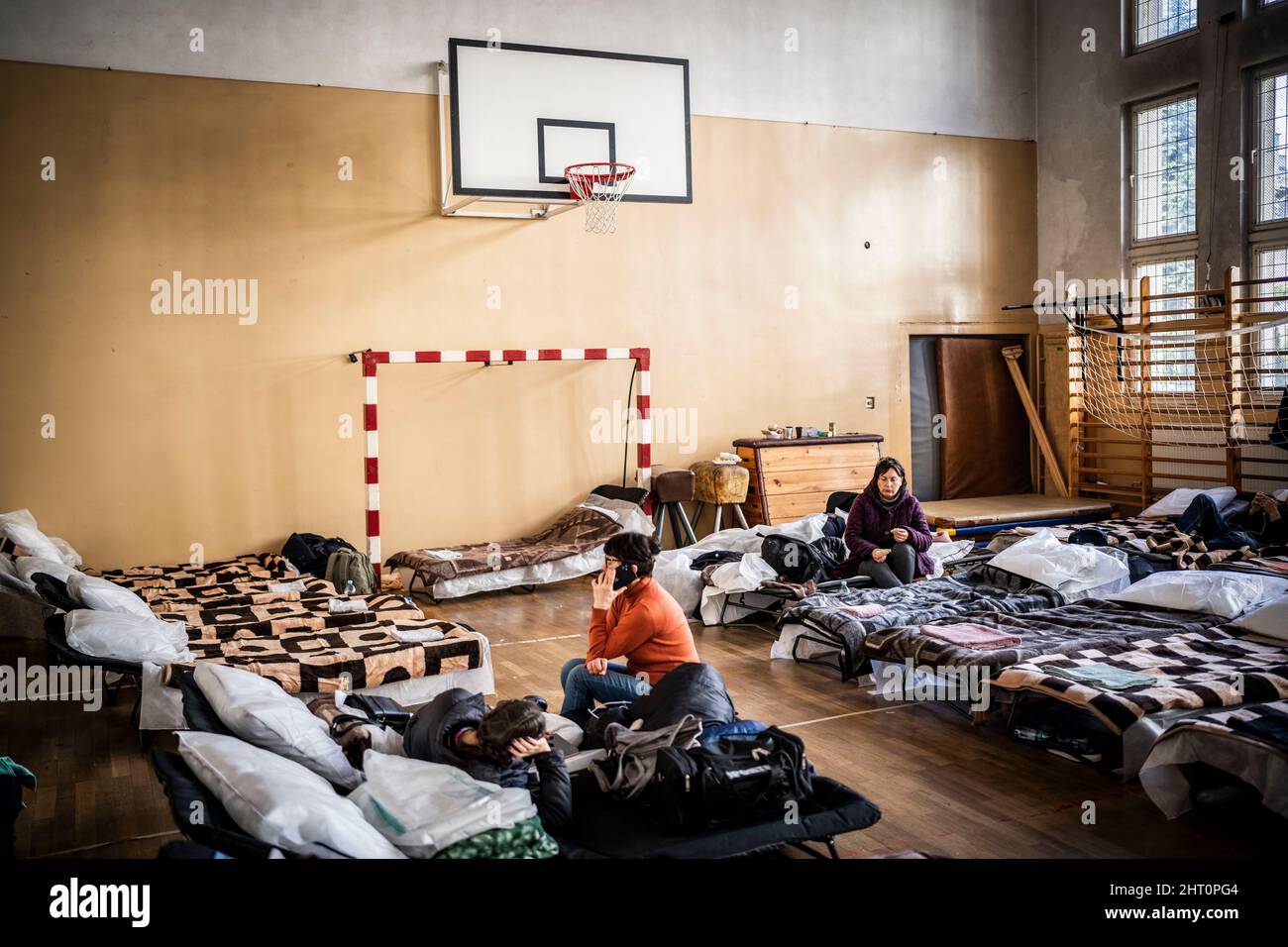 Przemysl, Polen. 26.. Februar 2022. Oksana aus der Ukraine (r) sitzt nach der Flucht aus der Ukraine in einer Notunterkunft in einer Schule. Zahlreiche Ukrainer verlassen das Land nach militärischen Aktionen Russlands auf ukrainischem Territorium. (To dpa 'Poland helps refugees') Quelle: Michael Kappeler/dpa/Alamy Live News Stockfoto