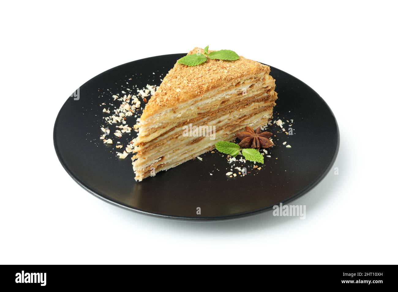 Teller mit Stück Honigkuchen isoliert auf weißem Hintergrund Stockfoto