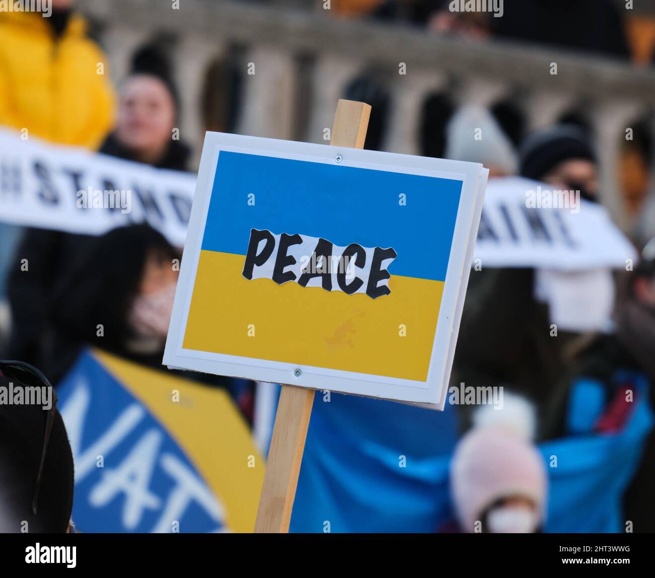 Halifax, Nova Scotia, Kanada. 26.. Februar 2022. Das Wort "Frieden" über der ukrainischen Flagge, als sich eine Menschenmenge vor dem Rathaus versammelte, um gegen den Krieg in der Ukraine zu protestieren. Stockfoto