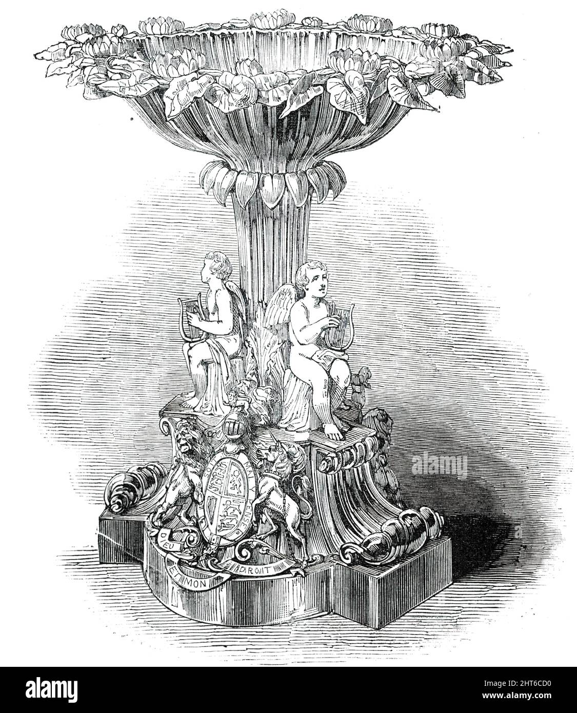 The Royal Font, 1850. „Diese interessante Schrift besteht aus einer dreieckigen Basis und einem Sockel mit auffälligem Design, auf beiden Seiten befinden sich die königlichen Wappen. Auf der Oberseite des Sockels, an der Unterseite eines Schaftes der Laubarbeit, sitzen drei Figuren von Kindern, die die Leier spielen. Der Schaft trägt eine Schale von eigentümlich anmutiger Umrisse, deren Rand Wasserlilien um sie herum hat, die wunderschön modelliert sind; eine einzelne Wasserlilie befindet sich in der Schale, was einen charmanten Effekt hervorbringt'. Die vergoldete Lily Font wurde von Königin Victoria von den Silberschmieden Edward Barnard and Sons in Auftrag gegeben. Es wird beim Taufgottesdienst verwendet Stockfoto
