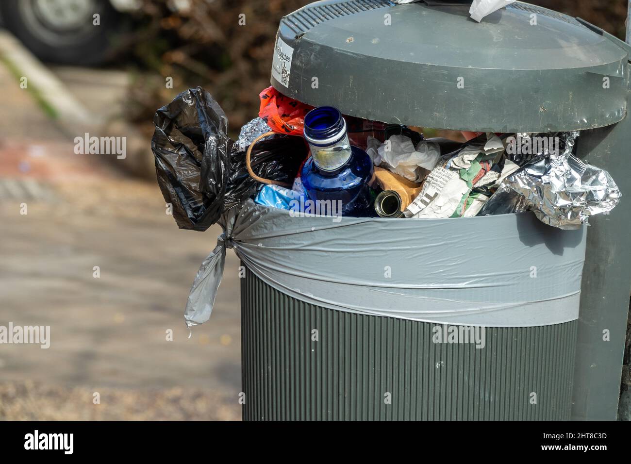 Mülltonne voller Müll auf einer Stadtstraße Stockfoto