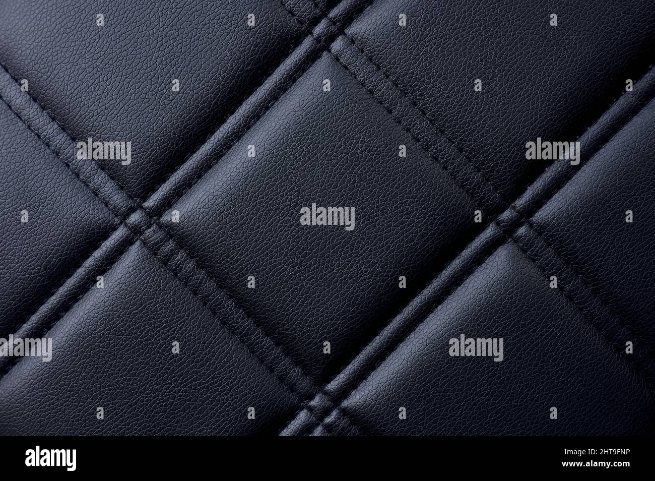 Strukturiertes Detail aus schwarzem Kapiton mit Diamanten oder Karos Stockfoto