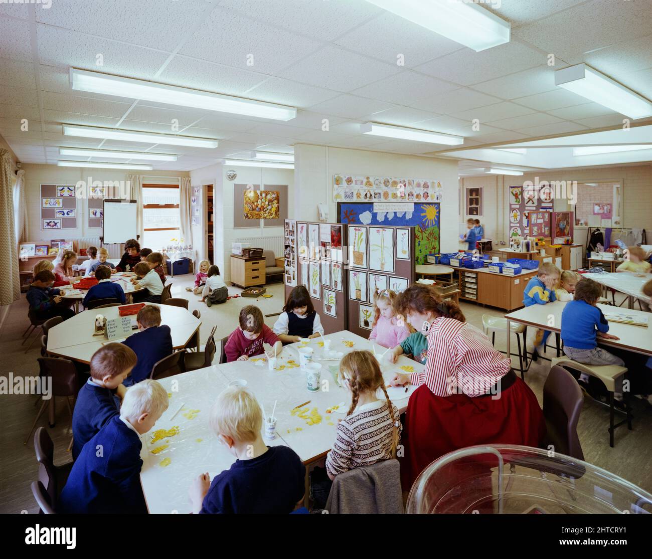 Whingate Primary School, Whingate Road, Leeds, 09/03/1989. Kinder, die an Tischen in einem Klassenzimmer der Whingate Primary School, Leeds, arbeiten. Laings Yorkshire Region Abteilung baute drei Schulen als kombinierte &#XA3;4m Vertrag für Leeds City Council. Whitecote, Harehills und Whingate-Grundschulen wurden alle zwischen September 1987 und September 1988 gebaut. Alle drei waren aus traditionellem Ziegelstein und Blockbau mit gekachelten Dächern. Das Design folgte der gleichen Vorlage, aber Whingate war ein Spiegelbild der beiden anderen. Stockfoto