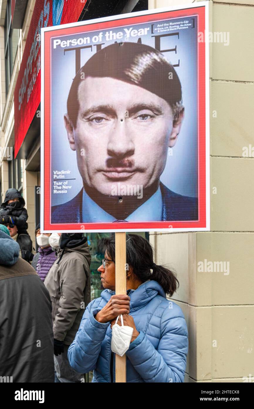 Toronto, Kanada - 27. Februar 2022: Eine Frau hält ein Zeichen, das Putin mit Hitler vergleicht. Die Kundgebung zur Unterstützung der Ukraine und gegen die russische Invasion st Stockfoto