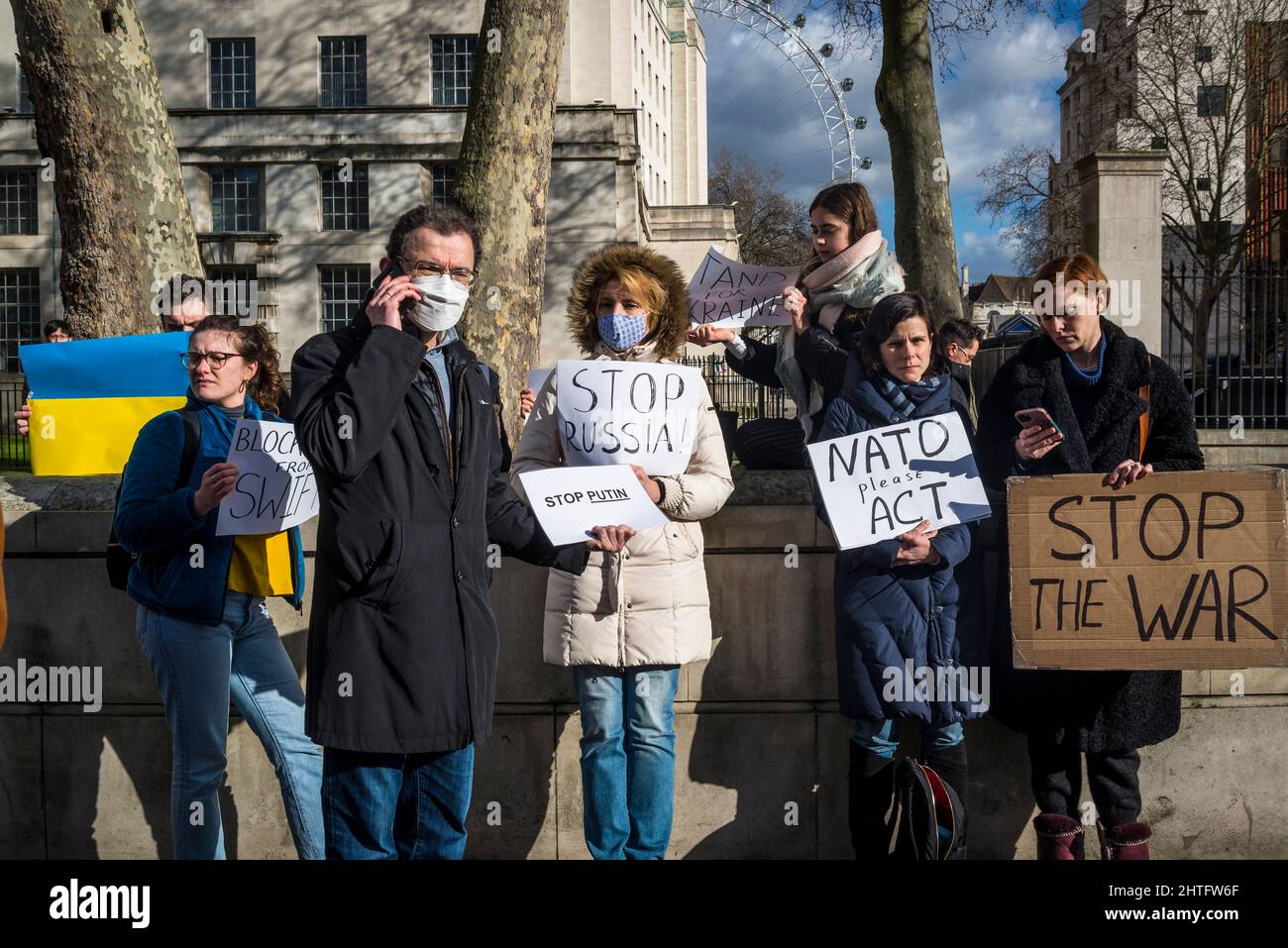 Demonstranten, die Plakate mit „Stop the war“ halten, gegenüber der Downing Street in Whitehall, London, Großbritannien Stockfoto
