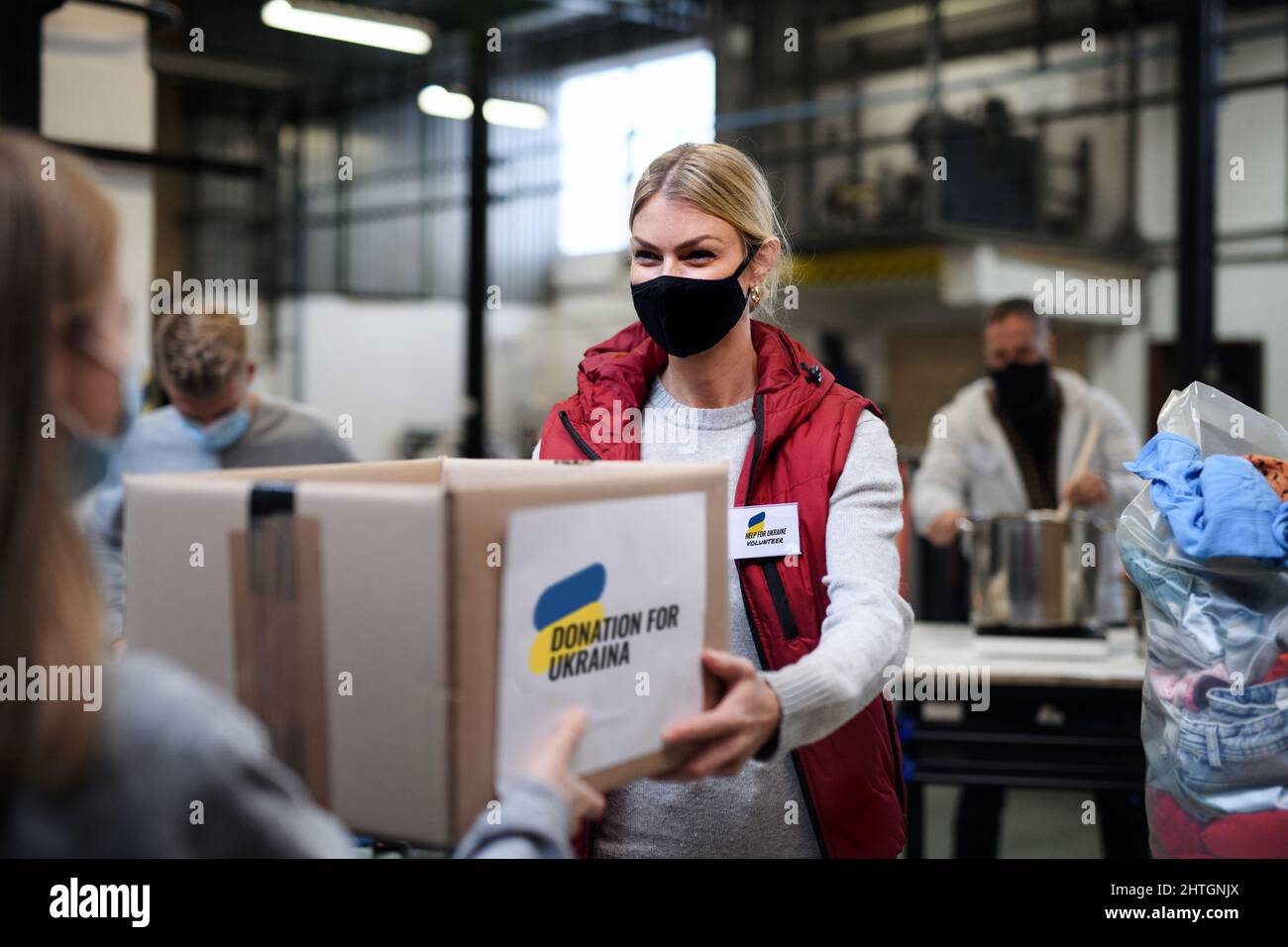 Volunteers collecting donations for the needs of Ukrainian migrants, humanitarian aid concept. Stockfoto