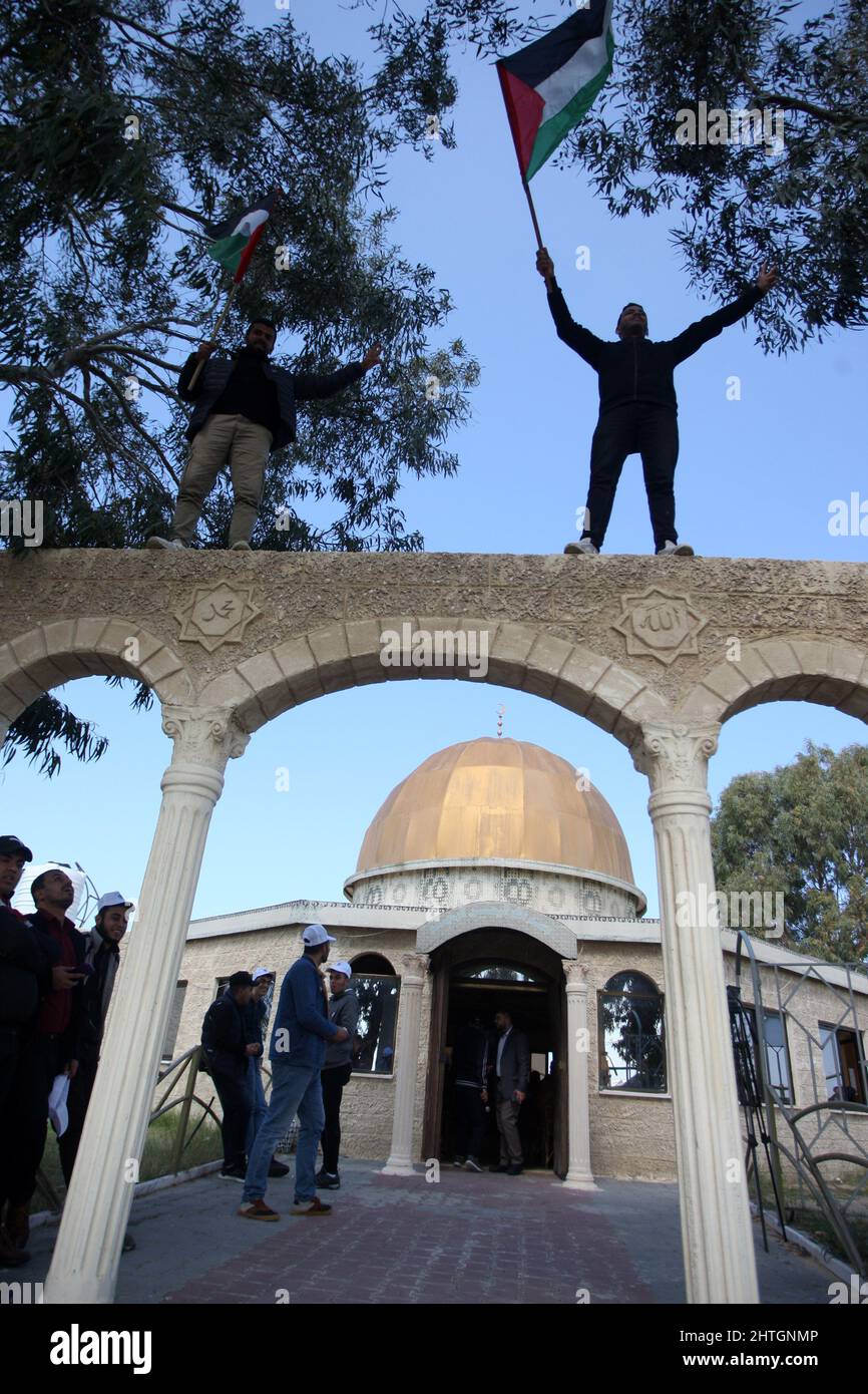 Khan Younis, Gaza. 28.. Februar 2022. Am Montag, den 28. Februar 2022, schwenken Palästinenser bei einer Kundgebung vor einer Nachbildung des Felsendoms der Al-Aqsa-Moschee in Khan Younis im südlichen Gazastreifen Nationalflaggen. Protest gegen eine berichtete Erklärung des französischen Premierministers Jean Castex, Jerusalem sei „die ewige Hauptstadt des jüdischen Volkes“, während einer Veranstaltung des Vertretungsrates der französischen jüdischen Institutionen in Paris. Foto von Ismael Mohamad/UPI Credit: UPI/Alamy Live News Stockfoto