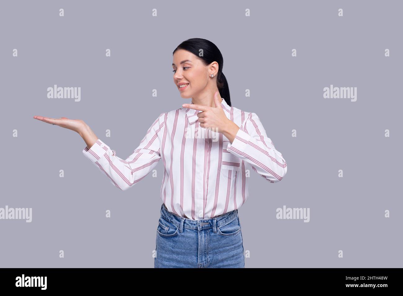 Mädchen hält Hand an Seite zeigt auf Hand isoliert Stockfoto