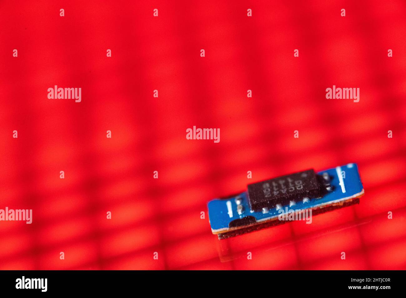 Bad Oeynhausen, Deutschland. 25.. Februar 2022. Ein Chip eines Smartphones liegt auf einer LED-Wand. Der weltweite Chipmangel hat die Weltwirtschaft gebremst. Quelle: Lino Mirgeler/dpa/Alamy Live News Stockfoto