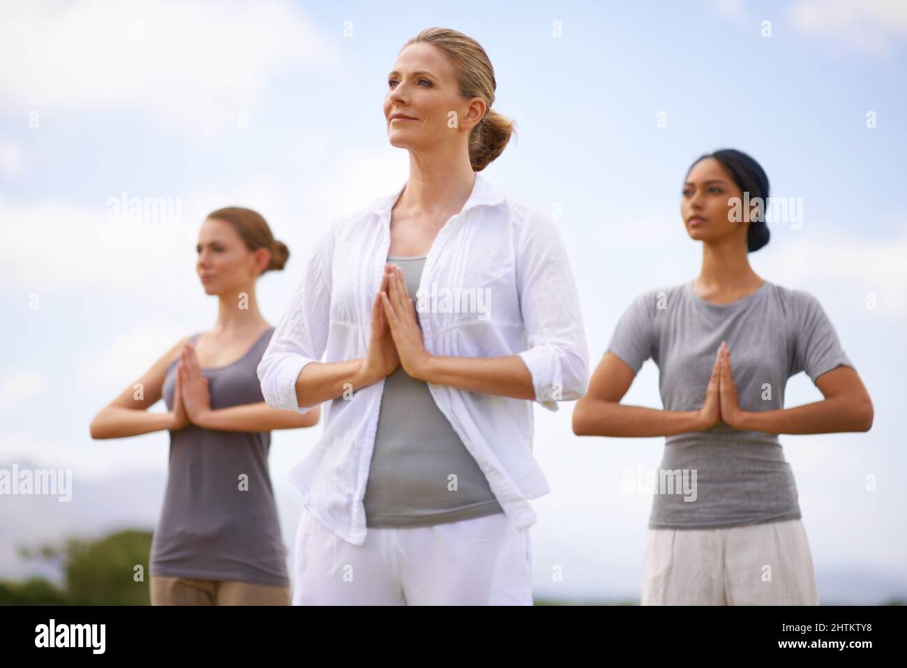 Sich um Körper und Geist kümmern. Frauen machen Yoga im Freien. Stockfoto