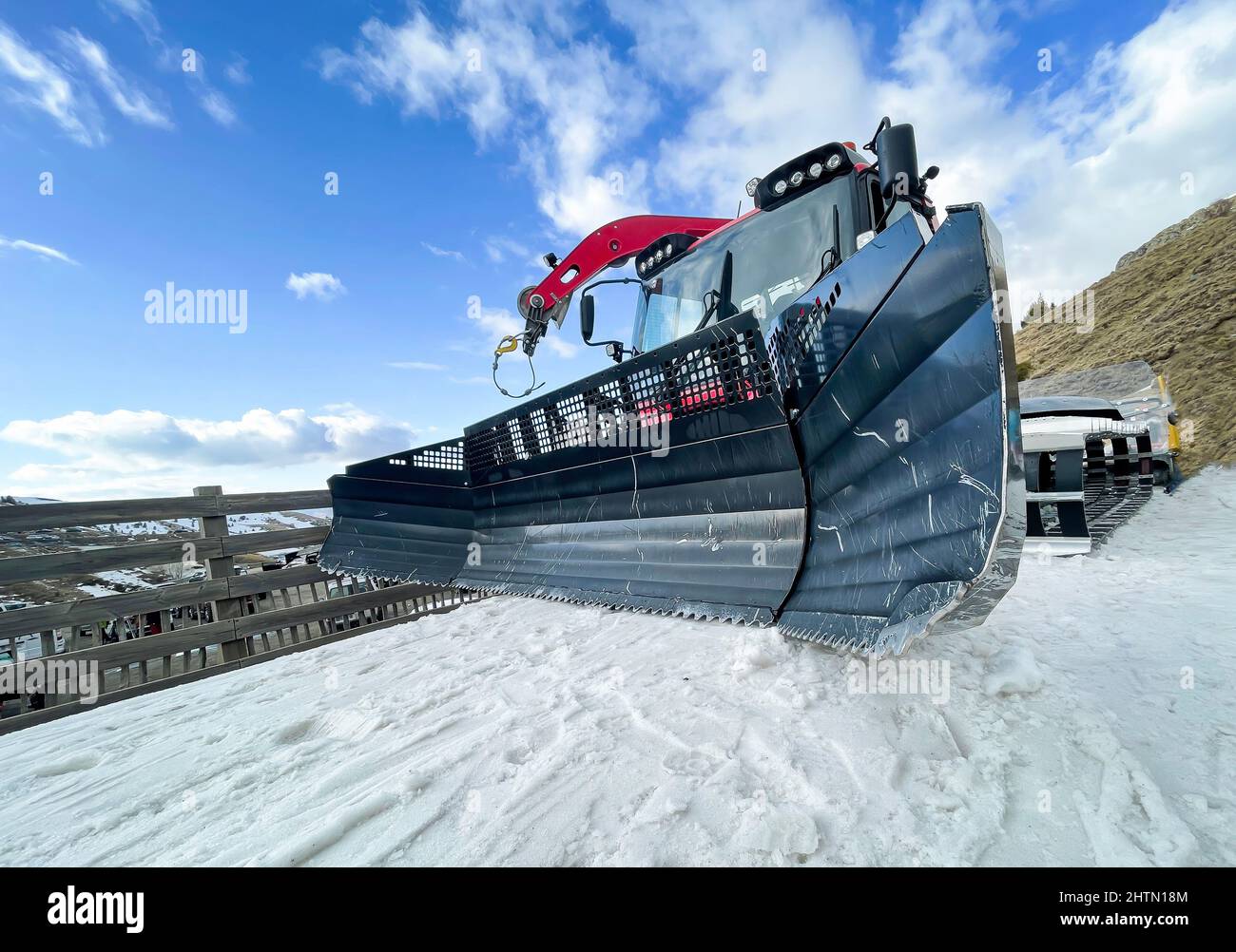Weitwinkelansicht der Schaufeln einer Schneekatze auf dem Schnee, Skiresidenz-Ausrüstung, Schneepflug-Maschine, Raupe Stockfoto