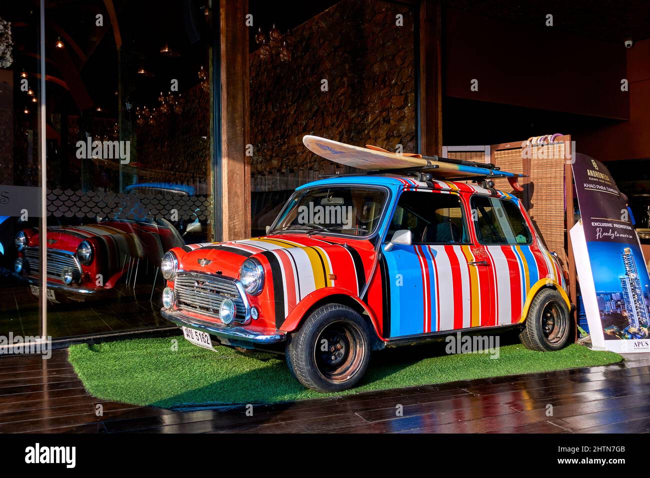 Paul Smith gestreifte Mini-Auto mit bunten Streifen mit Dach montiert Surfbrett lackiert. Fun Auto für junge Outdoor-Besitzer. Stockfoto