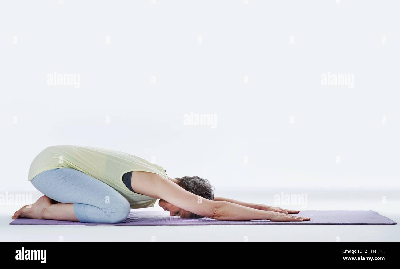 Stellen Sie sicher, dass Sie sich vor dem Training aufwärmen. Ganzkörperaufnahme einer attraktiven Frau, die sich vor dem Yoga dehnt. Stockfoto